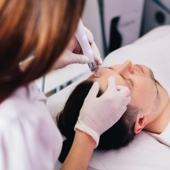 cosmetologist-doing-hydrafacial-treatment-on-man-f-2022-12-16-11-03-29-utc